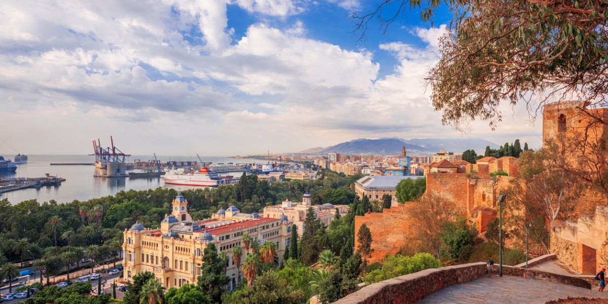 Scenic view of Málaga city and port with the Alcazaba fortress, historic buildings, and mountains in the background, Andalusia, Spain