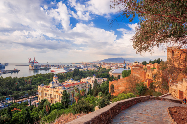 Scenic view of Málaga city and port with the Alcazaba fortress, historic buildings, and mountains in the background, Andalusia, Spain