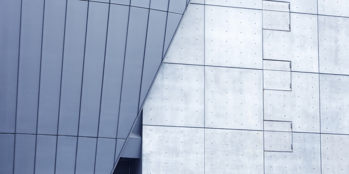 Modern building with large blue frosted glass windows aligned to a concrete wall.