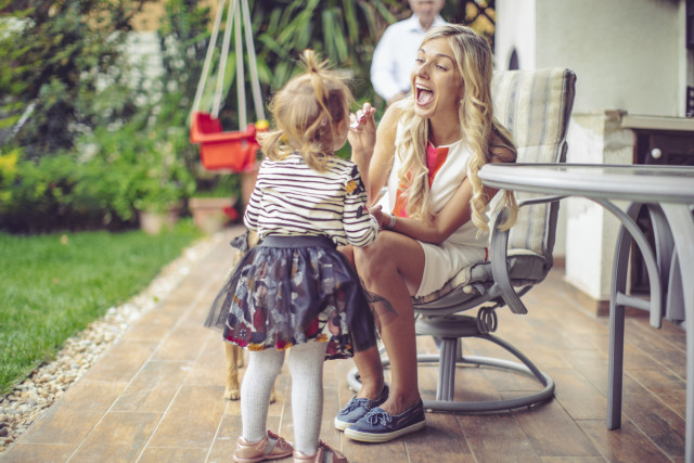Dutch family recently moved to Spain enjoying their beautiful new home where the mother feeds her baby girl.