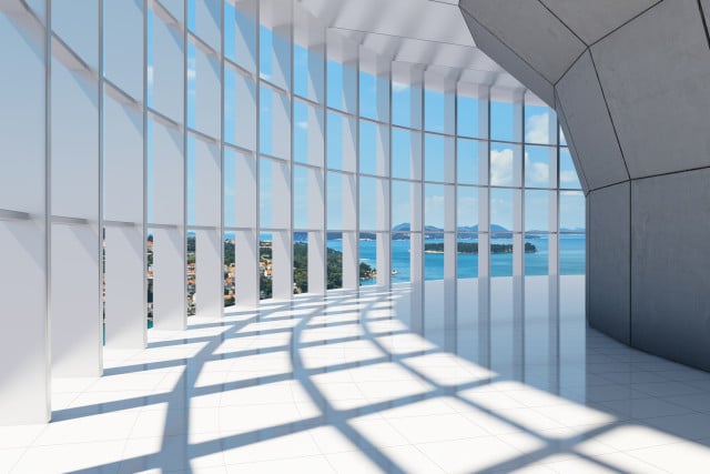 Modern building with a beautiful glass walkway overlooking the sea.