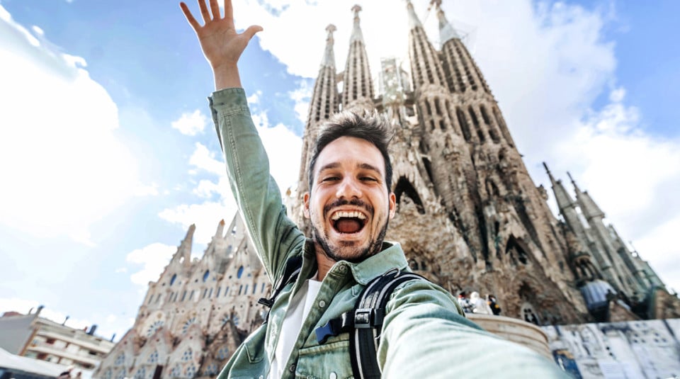 Tourist enjoying the city of barcelona with the sagrada familia in the background.